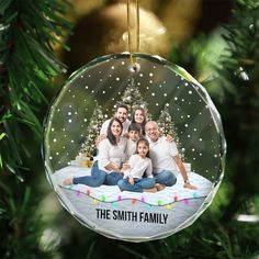 an ornament hanging from a christmas tree with the family on it's photo