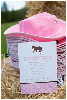 there is a pink hat on top of some hay