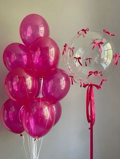 a bunch of pink balloons sitting on top of a table