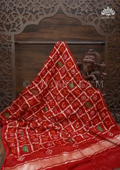 Gharchola is the traditional name for the pattern that a newly-wed bride in parts of Gujarat and Rajasthan adorns when she steps into her new home. The Dupatta is made of two words - 'Ghar' which means home, and 'Chola' which means attire. The square grids are symbolic of the houses.This Maroon Gharchola Dupatta has authentic Bandhni work done and embroidered elephant and peacock motifs adds to the cultural charm of it. This dupatta has pico done. It can be styled in many different ways and acce Peacock Motifs, Embroidered Elephant, Traditional Names, Newly Wed, Sarees Online, Free Giveaway, Wedding Bride, Elephant