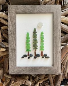 three trees made out of sea glass in a frame