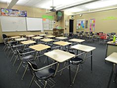 an empty classroom with desks and chairs