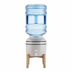 a water cooler sitting on top of a wooden stand