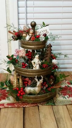 three tiered christmas tree with ornaments on top