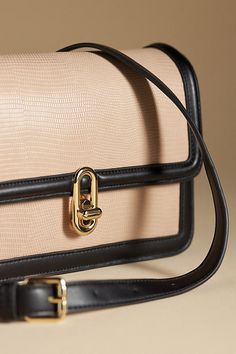 Polyurethane Adjustable crossbody buckle strap One inner slip pocket Turnlock flap closure Imported | Mia Turnlock Bag by Jules Kae in Pink, Women's, Polyurethane at Anthropologie Office Flap Shoulder Bag With Hasp Closure, Luxury Satchel Shoulder Bag With Buckle Closure, Flap Shoulder Bag With Hasp Closure For Business, Beige Office Bag With Turn-lock Closure, Business Flap Shoulder Bag With Hasp Closure, Business Shoulder Bag With Flap Hasp Closure, Business Shoulder Bag With Flap And Hasp Closure, Elegant Crossbody Shoulder Bag With Buckle Closure, Office Satchel With Turn-lock Closure