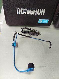 a pair of headphones sitting on top of a table next to a black case