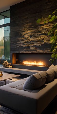 a living room with a couch, fireplace and large glass doors that open to the outside