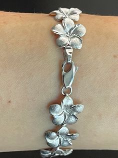 Elegant And Beautiful Hawaiian 14mm Plumeria Flower Lei Bracelet 7 1/4" in 14K Solid White Gold  Diamond Cut on the edges of each petal. 14 Karat Solid White Gold GUARANTEED, Authenticated with a 14K Stamp Made With the Highest Quality Craftsmanship Solid 14K White Gold Plumeria Flower Lei Link Bracelet  Length 7.25 Inches Solid 14K White Gold Plumeria Flower Width 14 Millimeters Total Weight 15.8 grams Amazing! Gift For Family And Friends! A Bracelet Jewelry Gift Box Included! Silver Flower Jewelry, Cute Silver Jewelry, Heavy Jewelry, Silver Flower Bracelet, Gold Schmuck, Flower Lei, Plumeria Flowers, Friend Jewelry, Jewelry Accessories Ideas