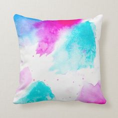 a colorful pillow with watercolor paint on it