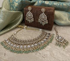 Grand mintgreen bridal kundan jewelry set that stands out for being unique and beautiful!  Radiate splendour in this green kundan bridal set with beautiful chandbalis. The set includes a necklace, a pair of beautiful chandbali earrings and a matching tika.  Details: Necklace Width-3 Inches Earrings Length-4 Inches Earrings Width-1.25 Inches Weight of Each Earring-29 gms Tika Length-5.5 Inches All products are manufactured using traditional skills from our rich heritage of crafts.  The process of Traditional Green Kundan Sets, Green Kundan Jewelry Set, Traditional Kundan Dual-tone Jewelry Sets, Green Hand-set Round Kundan Necklace, Kundan Bridal Set, Traditional Green Kundan Necklace, Luxury, Indian Jewelry Set, Kundan Jewellery Bridal, Jewelry Kundan