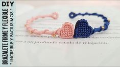 the bracelet is made out of two pieces of crocheted fabric and has a heart shaped bead on it