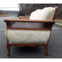 an old chair sitting in the middle of a parking lot with no one around it