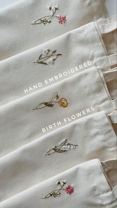 five embroidered napkins with flowers on them