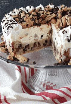 a chocolate chip ice cream cake on a glass platter with one slice cut out