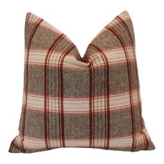 a brown and red plaid pillow on a white background