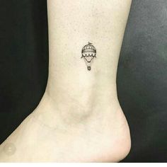 a small hot air balloon tattoo on the ankle