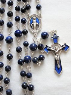 This lapis lazuli rosary can also be worn as a necklace. The body is about 27 inches and the cross extension is 6 inches. The blue enameled cross and connection were made in Italy and are oxidized silver. I used 6mm and 8mm lapis rounds and hand turned each of the wires myself. The crucifix is 1 and 3/4 inches long. This rosary will be slipped into an organza bag and shipped in a bubble mailer. Blue Crucifix Necklace For Spiritual Wear, Blue Crucifix Necklace For Spiritual Purposes, Blue Rosary With 8mm Beads And Crucifix, Blue Rosary With 8mm Beads In Cross Shape, Blue Rosary With 8mm Beads For Healing, Blue Rosary With Round Beads For Healing, Blue Spiritual Rosary With Gemstone Beads, Spiritual Blue Rosary With Gemstone Beads, Blue Gemstone Beads Rosary For Spiritual Use