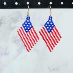 Celebrate the 4th of July, or any day, with these fun American Flag earrings! Perfect for showing off your patriotism! Also available in clip ons for no extra charge. Measures about 2 inches from base of earring hook. This pair of earrings is made-to-order. Please allow 3-5 business days for processing. Blue Patriotic Earrings For Independence Day, Patriotic Earrings For 4th Of July, Patriotic Blue Earrings For Independence Day, Patriotic 4th Of July Earrings, Red Patriotic Beaded Earrings, Independence Day Dangle Earrings As Gift, Independence Day Dangle Earrings Gift, Independence Day Gift Dangle Earrings, Patriotic Beaded Earrings For 4th Of July