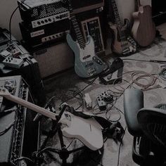 a room filled with guitars, amps and other musical equipment