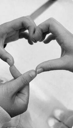 two hands making a heart shape with their fingers