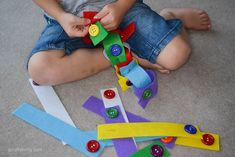 a toddler playing with some colorful toys on the floor