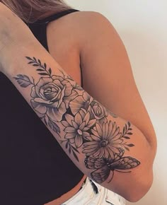 a woman's arm with flowers on it