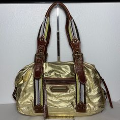 New With Tag, Some Tarnishing On Rivets. Style Is Called Fast Lane Sondra Bag. Gold Foil With Olive Lining. Exterior Front Has One Zippered Pocket, Back Has Pocket With Magnetic Flap. Interior Has Four Pockets And One Is Zippered. Dust Bag Included. 14”L X 5”W X 8.5”H (17”H With Handle) Gold Satchel Shoulder Bag With Brass Hardware, Gold Satchel With Brass Hardware, Gold Satchel Shoulder Bag For Travel, Gold Shoulder Bag With Brass Hardware For Travel, Gold Rectangular Bag With Brass Hardware, Gold Bags With Brass Hardware, Rectangular Shape, Gold Rectangular Bags With Brass Hardware, Gold Satchel With Metal Hardware And Double Handle, Gold Shoulder Bag With Double Handle And Metal Hardware