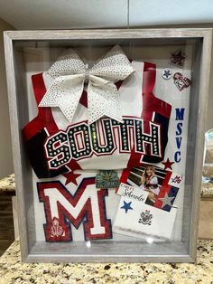 a display case with the words south and pictures in it, including two large bows