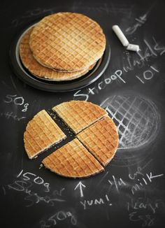 two waffles are cut in half on a chalkboard