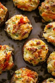 baked stuffed mushrooms with tomatoes and cheese on a baking sheet, ready to be eaten