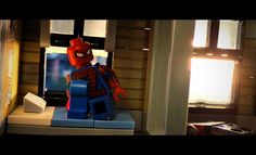 a lego spider man is on display in front of a television set with the window open