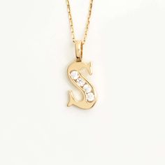 Add a touch of brilliance to your style with our Custom CZ Initial Pendant in 14K Gold. This exquisite piece showcases your chosen initial in dazzling cubic zirconia stones, set in a lustrous 14K gold pendant. Complete it with your charm and elevate your look with a personalized touch of elegance and sparkle. 14k solid gold handcrafted pieces 100% ethical sourced jewelry Material: 14k Solid Gold CZ Quality:Carat Weight: 0.10 ctwColor: F-GClarity: VS2Cut: Excellent Pendant Height: 20 mm / 0.79 in Cubic Zirconia Initial Pendant Necklace, Gift Cubic Zirconia Diamond Necklace With Initial Pendant, Personalized Diamond Initial Necklace In Yellow Gold, Yellow Gold Cubic Zirconia Initial Pendant Necklace, Yellow Gold Cubic Zirconia Initial Necklace, Gold Initial Necklace In Cubic Zirconia, Gold Initial Necklace With Single Diamond For Anniversary, Yellow Gold Initial Necklace With Diamond Accents, Yellow Gold Initial Necklace With Diamond Accents As Gift