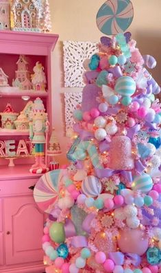 a pink and blue christmas tree decorated with candy