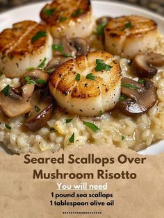 a white plate topped with scallops and mushroom risotto next to a piece of parchment paper