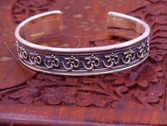 Excellent handmade 925 sterling silver Hindu mantra Aum bracelet, vintage antique stylish unisex gifting oxidized jewelry from Rajasthan india.Metal-925 sterling silver.Type-Bracelet/ kada.Size-Adjustable.Width-1.4 centimeters.Weight-42.470 grams approx.Finish-Oxidized.Stamped-925.Makes excellent gifting for birthday, wedding anniversary, mother's day, father's day Traditional Nickel-free Cuff Bracelet As Gift, Traditional Nickel-free Cuff Bracelet Gift, Handmade Silver Brass Cuff Bracelet, Handmade Brass Silver Cuff Bracelet, Silver Spiritual Toe Ring Jewelry, Spiritual Silver Toe Ring Jewelry, Traditional Adjustable Antique Silver Cuff Bracelet, Adjustable Antique Silver Traditional Cuff Bracelet, Adjustable Traditional Antique Silver Cuff Bracelet