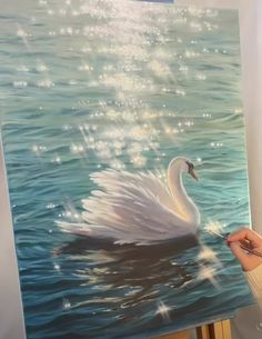 a painting of a white swan floating in the water with sparkling lights on it's wings