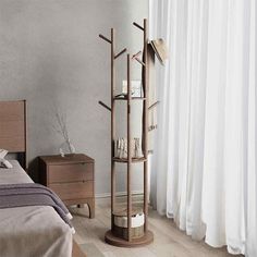 a bed room with a neatly made bed and a tall wooden shelf next to the window