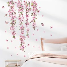 a bedroom with pink flowers and butterflies on the wall