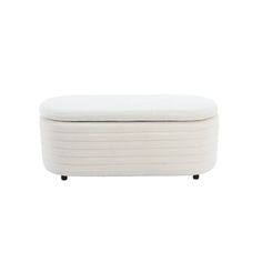 a white ottoman sitting on top of a wooden table