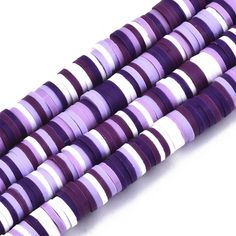 purple and white striped beads are stacked on top of each other