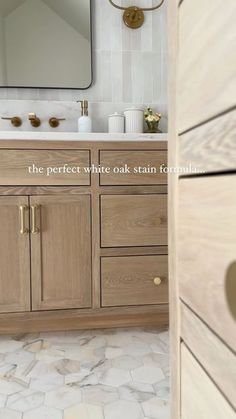 a bathroom with wooden cabinets and marble counter tops