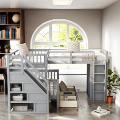 there is a loft bed with stairs and bookshelves in the room next to it