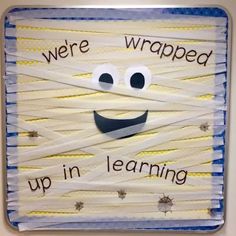 a piece of art that says, we were wrapped up in learning with yarn and scissors