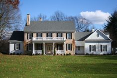 a large white house with black shutters on the front