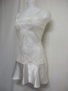 "Short White Lace and Satin Nightgown Unbelievably adorable! Sheer Baby doll /white nightie! Tons of lace with a satin flouncy skirt This is sassy! (Like You!) Small 36\" bodice 40\" Hip 32\" length Easy care poly GREAT for brides! https://www.etsy.com/shop/BelindasStyleShop" Delicate Lace Trim Sleepwear For Wedding Night, Wedding Night Camisole Dress With Delicate Lace, White Lace Feminine Slip Dress, White Satin Nightgown With Spaghetti Straps, Elegant Lace Trim Chemise For Bedtime, Delicate Lace Slip Dress With Lace Trim, White Satin Camisole Nightgown, White Lace Bodice Flirty Dress, Coquette Lace Trim Sleep Chemise