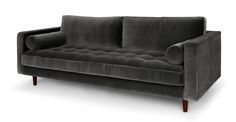 a green velvet couch with wooden legs