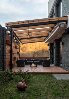 an outdoor living area with wooden decking and patio furniture