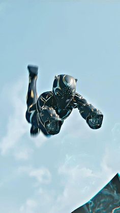 a man flying through the air while riding a skateboard in front of a blue sky