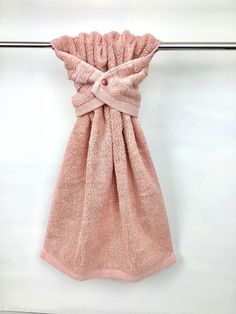 a pink towel hanging on a clothes line