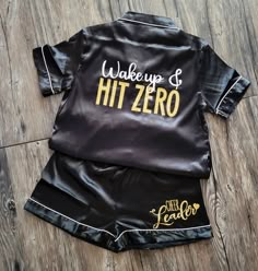 a black shirt and shorts with the words wake up and hit zero printed on it